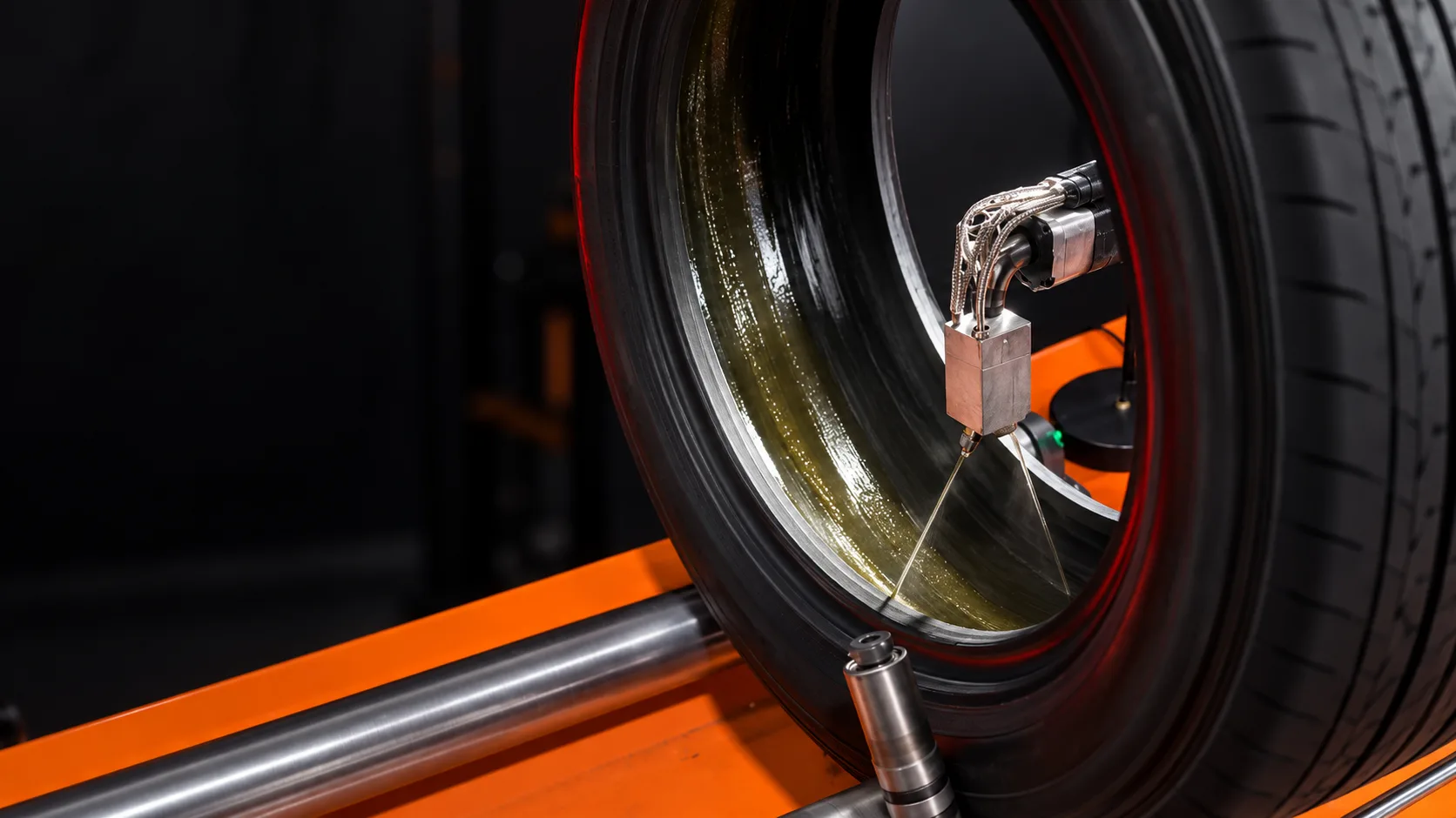 Sealant being applied across the inside of a tire